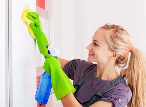 Cleaner using safe methods with protective equipment in a tidy environment
