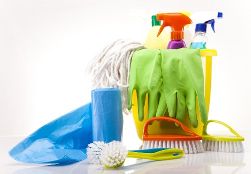Cleaning a living room in a Watford flat before handover
