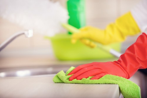 Domestic cleaner tidying a kitchen in Watford